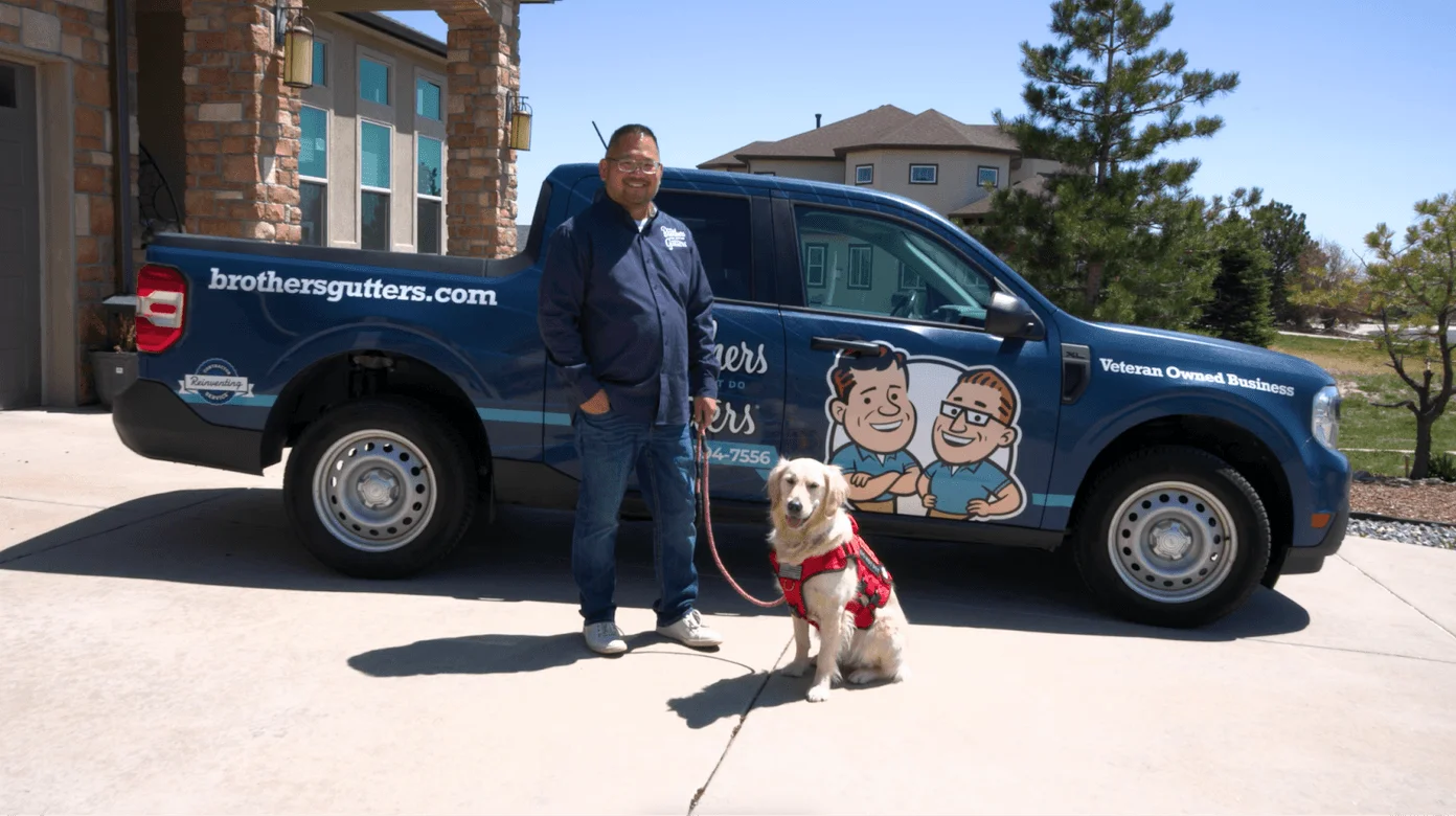 James Estes and Lou Lou infront of Brothers Gutters Truck